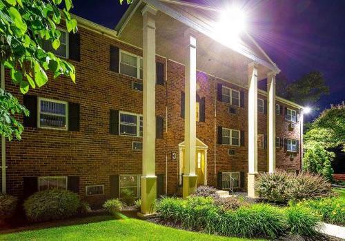 Lighted exterior view of a residential building at night at 沃灵顿口岸 apartments for rent